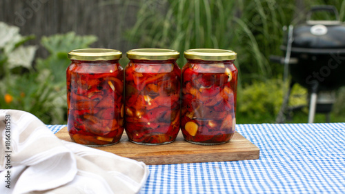 Εκτύπωση καμβά Three jars of fiery pickled peppers evoke summer barbecues and Home Canning Day,