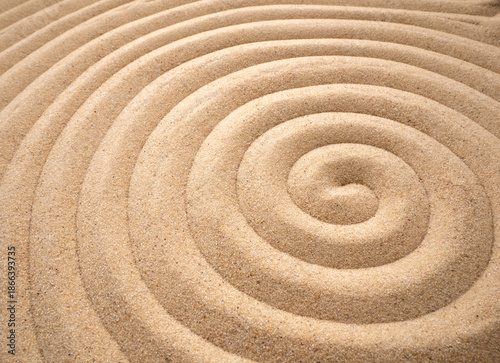 sand spiral symbolizing the sun, peace, zen. Drawing on the sand helps you find peace and tune in to meditation