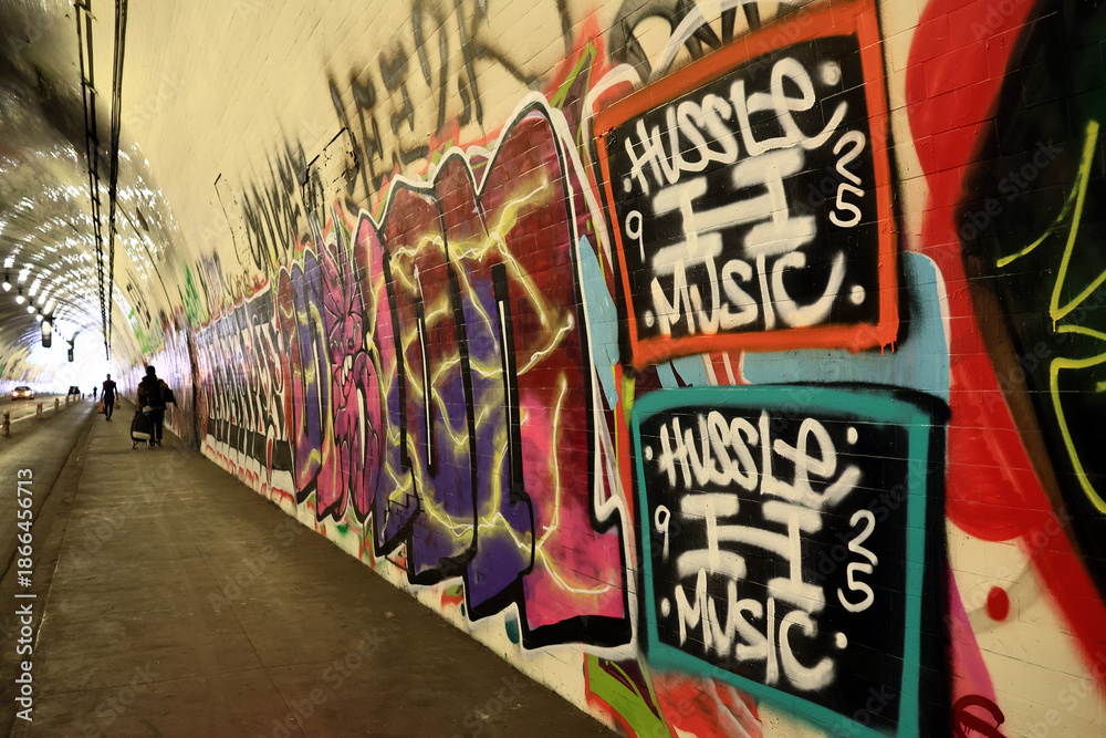 Fototapeta premium Los Angeles, California – November 21, 2025: Iconic 2nd Street Tunnel under Bunker Hill covered with graffiti, famous filming location featured in movies and TV productions, Downtown Los Angeles 