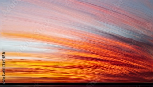 Abstract colorful sunset with streaks of orange and red light in the sky
