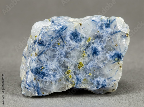 Entangled fibrous blue glaucophane crystals forming a dense amphibole aggregate within a granular metamorphic quartzite.