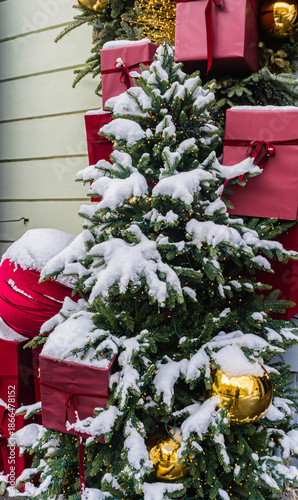 christmas tree covered in snow and red gifts decoration minimalist 