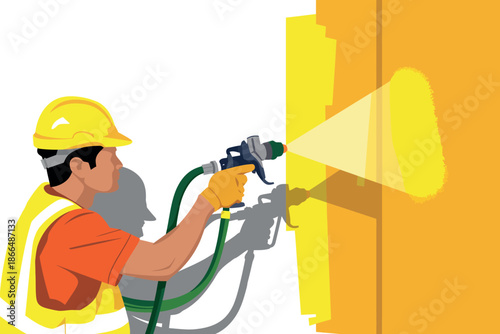 Worker spray paints a wall.