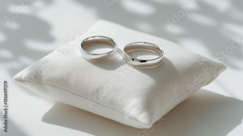 Elegant wedding rings displayed on a soft pillow, symbolizing love and commitment. Perfect for wedding planning and romantic themes.