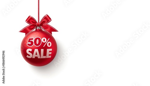 A red Christmas ornament with a 50% sale sign hanging from a ribbon on a white background