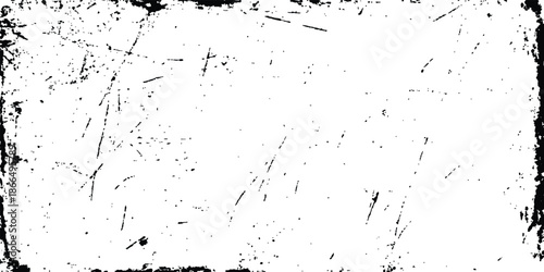 A high-contrast grunge texture overlay with distressed black speckles and scratches. Abstract grunge texture with sharp black scratches and distressed lines on a white background. textured background.