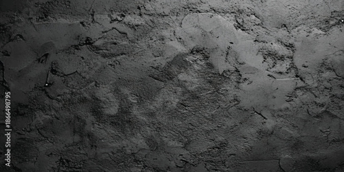 Grungy, dark grey plaster texture background with rough and uneven surface details