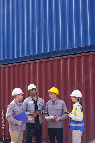 Staff workers or foremans or engineers check inventory in port cargo container shipping yard warehouse. Transport, import, export logistic industrial.