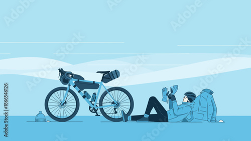 Cyclist Resting After A Long Ride In A Monochrome Winter Landscape