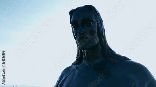 Catholic metal structure in Mexico showing Christ the King at sunrise among mountains