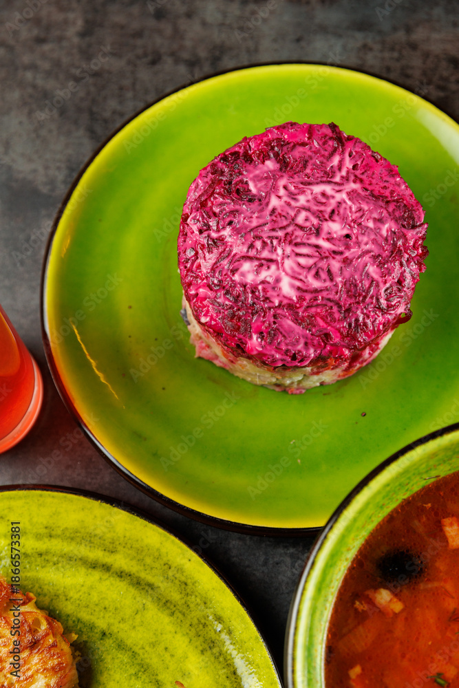 Obraz premium Explore various dishes from Ukrainian cuisine and Japanese cuisine displayed on colorful plates in a vibrant setting