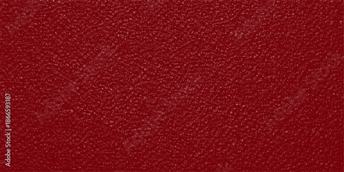 A macro shot of a dark red leather texture background featuring a rough material pattern and aged surface structure for a fashion design textile backdrop