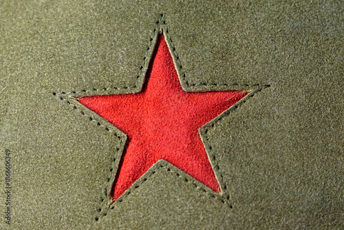 Red star symbol at green textile