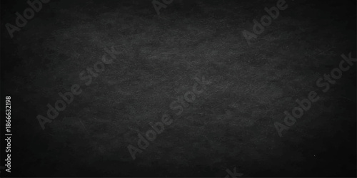 A dark and empty black grunge paper background featuring a vintage textured wall design with scratched gray stone patterns and a dirty old chalkboard backdrop