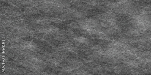 A vintage dark grunge texture featuring a blend of rough black fabric and old gray paper patterns on a weathered blank stone surface backdrop