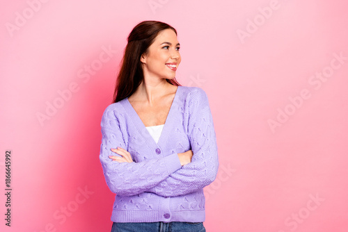 Tableau sur toile Casual chic woman smiling in lavender cardigan against pink background suitable