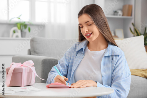 Young woman writing love le...