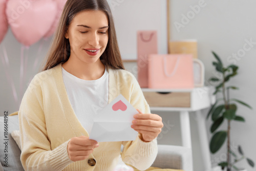Young woman with love lette...