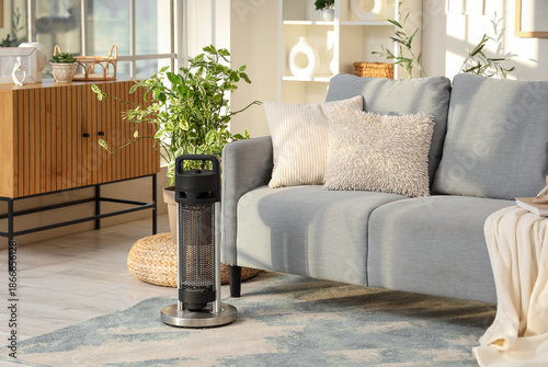 Electric heater near sofa i...