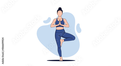 Woman in blue sportswear practicing yoga in the tree pose for balance and concentration as part of a healthy fitness lifestyle.