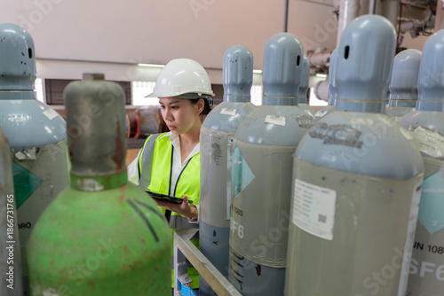 Industrial safety inspection of pressurized gas cylinders, focusing on hazardous material management, risk assessment, and regulatory compliance in an indoor facility.