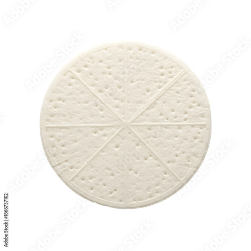 Stack of homemade peanut butter cookies on a plate with a glass of milk and napkin on a dark wooden table, warm lighting