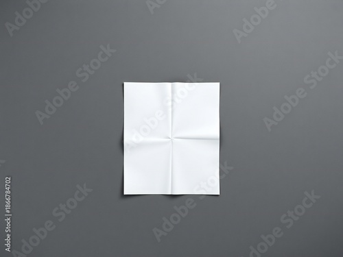 Blank folded paper on a dark gray background
