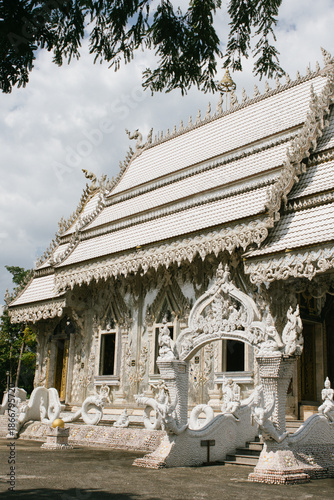 Beautiful exterior of Wat Phu Nam Ron Ratchaburi. This Thai Buddhist temple is known for its ornate white design and unique artistic decoration.