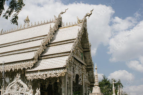 Beautiful exterior of Wat Phu Nam Ron Ratchaburi. This Thai Buddhist temple is known for its ornate white design and unique artistic decoration.