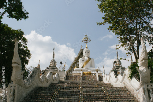 Beautiful exterior of Wat Phu Nam Ron Ratchaburi. This Thai Buddhist temple is known for its ornate white design and unique artistic decoration.