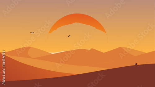 Paraglider soaring over desert dunes at sunset