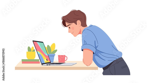 A man leaning over a desk with a laptop and various office supplies on it