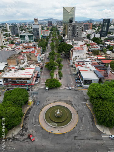 Aerial vertical image of Chapultepec Avenue lined with trees and central fountain in Guadalajara, Mexico