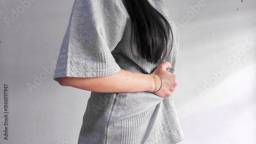 Bild auf Leinwand Woman holding stomach in pain, abdominal pain and stomach ache concept