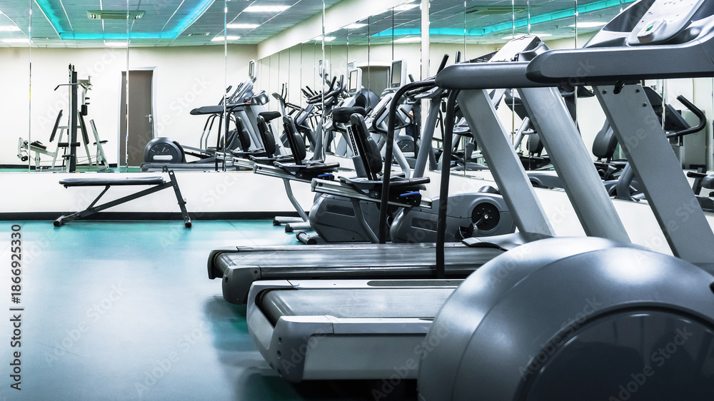 Fototapeta premium Fitness center with multiple treadmills and exercise equipment in clear view
