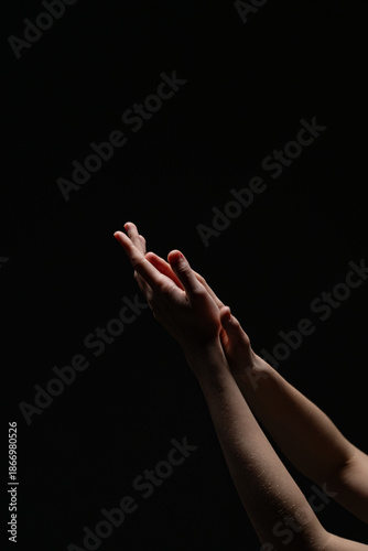 Wallpaper Mural Two softly lit female hands in a gentle, upward gesture against a dark background. A minimalist and emotional composition highlighting skin tone and texture Torontodigital.ca