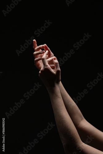 Wallpaper Mural Close-up of two feminine hands in a soft, poised gesture illuminated against a black background. A minimal, expressive composition with emotional tone Torontodigital.ca