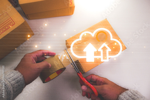 Streamline your business with cloud-based logistics. A person packs a box with a glowing cloud upload icon, symbolizing digital supply chain management.