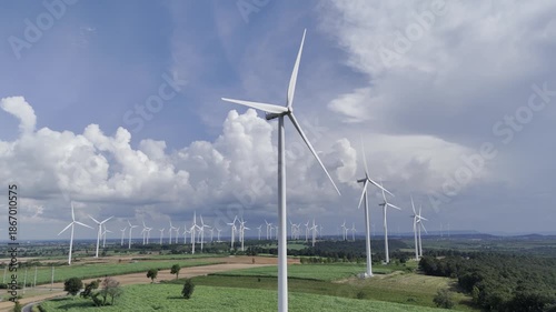 Wind turbines at green mountain hill clean sustainable electricity power, Green generator cloud blue sky fly over with drone shot