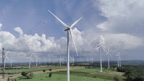 Wind turbines at green mountain hill clean sustainable electricity power, Green generator cloud blue sky fly over with drone shot