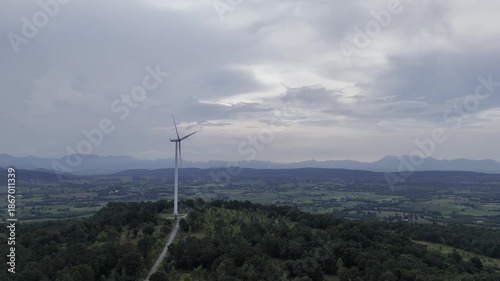 Closeup beautiful solo wind turbine at green mountain hill clean sustainable electricity power, Green generator cloud blue sky