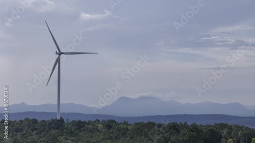 Closeup beautiful solo wind turbine at green mountain hill clean sustainable electricity power, Green generator cloud blue sky