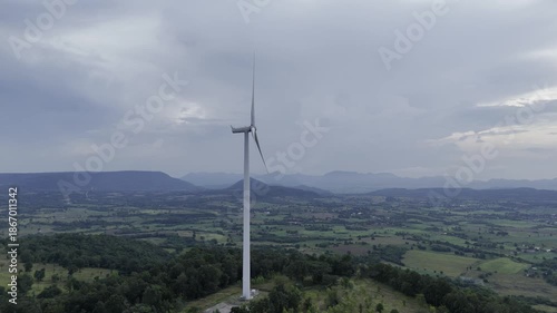 Closeup beautiful solo wind turbine at green mountain hill clean sustainable electricity power, Green generator cloud blue sky