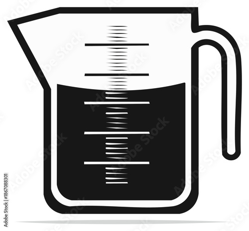 Measuring cup filled with liquid displays graduated markings for accurate volume measurement