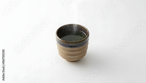 a cup of hot green tea, matcha served in rustic two toned ceramic cup isolated on white background
