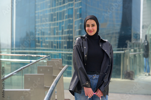 Young muslim woman with hijab in front of the modern building