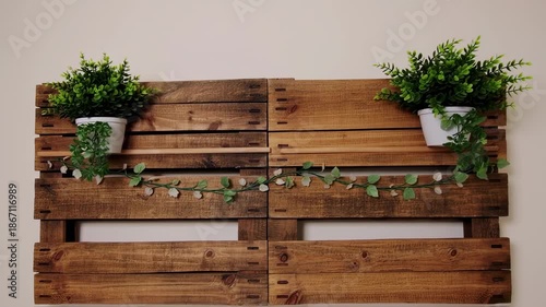 Rustic wall decor with a wooden pallet design, featuring plants in white pots