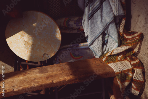 Workers' rest bench with clothes and miscellany in 1980s Hong Kong with old filter