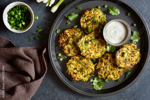 Vegetable vegetarian zucchini fritters served with sauce