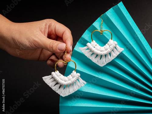 Fotografie Minimalist Macrame Heart Shape Earrings with Golden Hoop on Fan